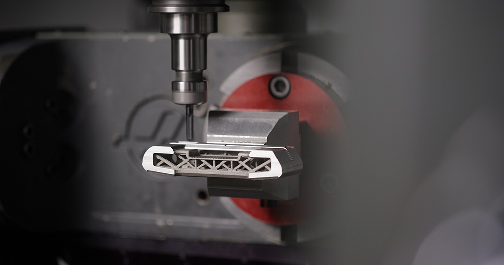 CNC milling process of a COBRA golf club head using Mastercam Dynamic Motion technology, showcasing the intricate design and precision of golf equipment manufacturing.