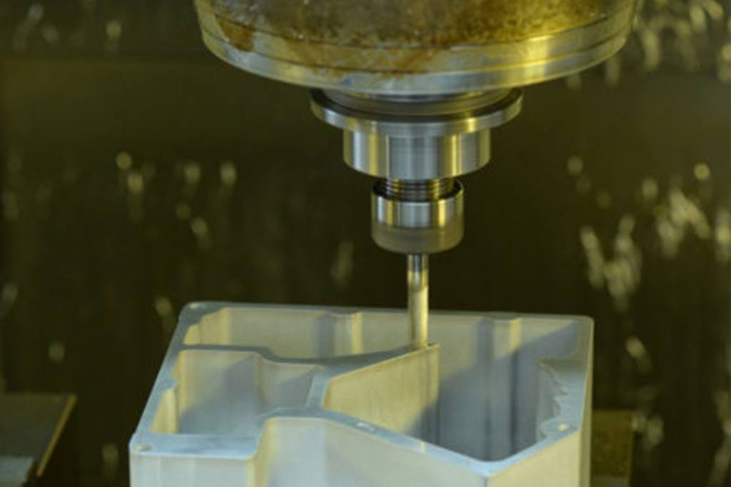 CNC milling machine cutting a complex part, showcasing precision machining for medical device prototypes, emphasizing tight tolerances and efficient material removal.