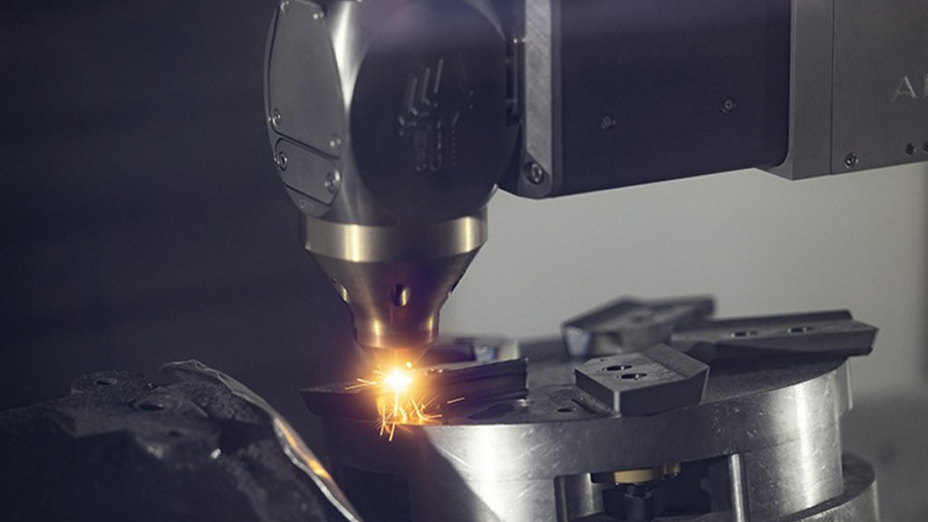 Laser additive manufacturing process for MLX knife tips, showcasing precision equipment and molten material application in advanced manufacturing.