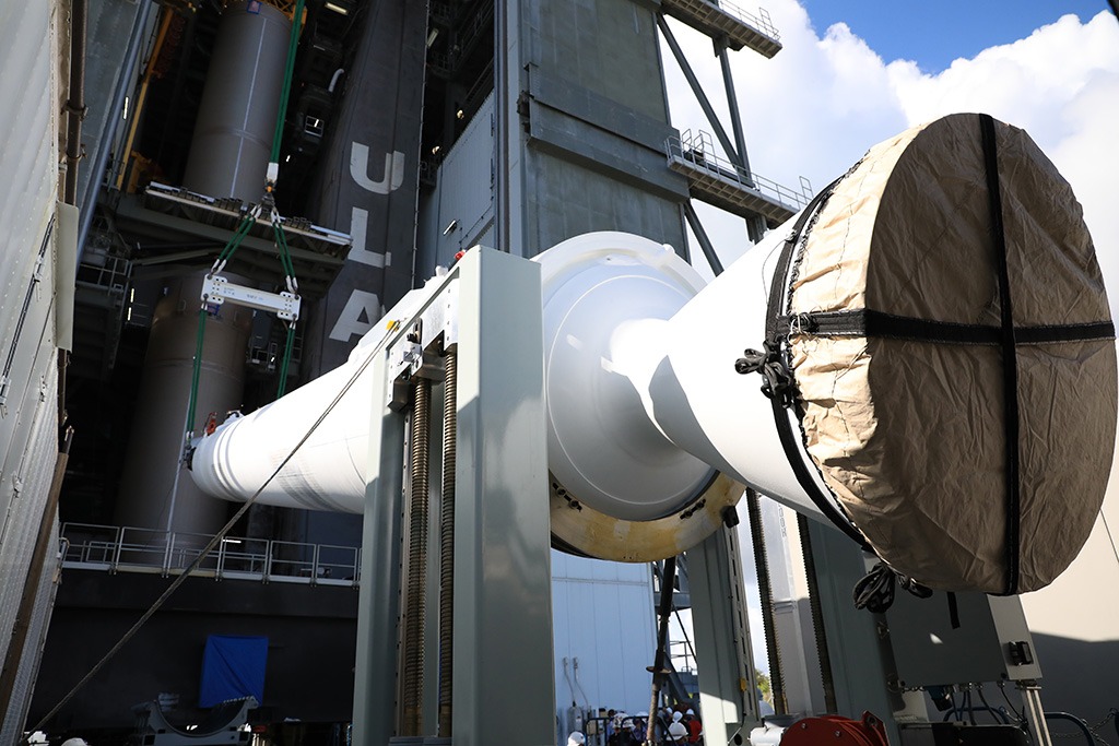 Atlas V solid rocket booster being positioned on Roll-over Stand at Napoleon Machine facility, showcasing advanced manufacturing capabilities for aerospace applications.