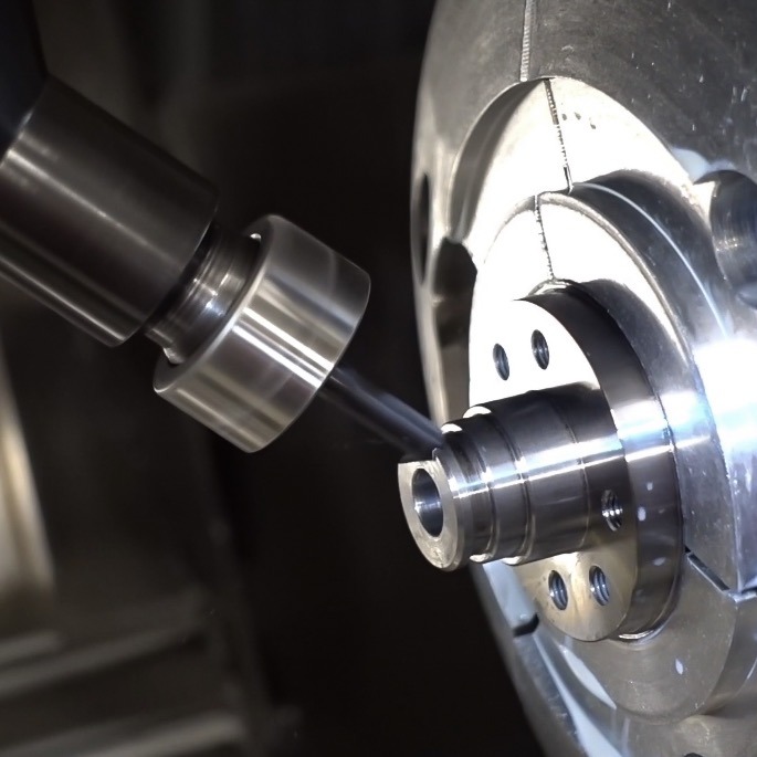 CNC machine toolhead cutting a precision component on a Mazak Integrex, showcasing advanced manufacturing techniques for dual-toolhead operations.